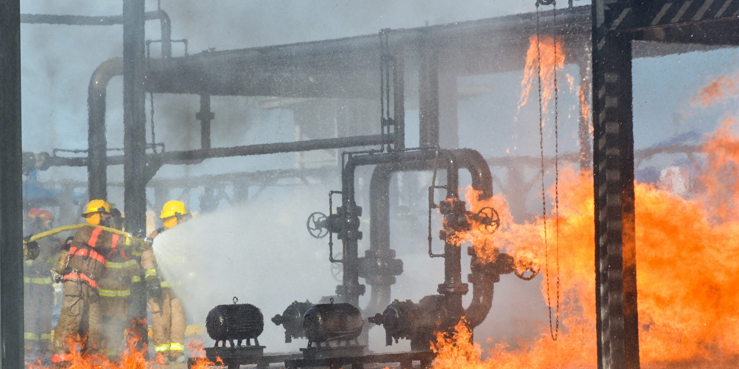 Fire fighters battling a blaze at oil pipeline refinery